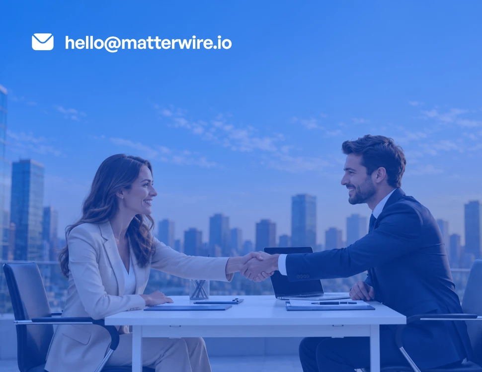 Two colleagues shaking hands over a desk, with the Matterwire contact email displayed.