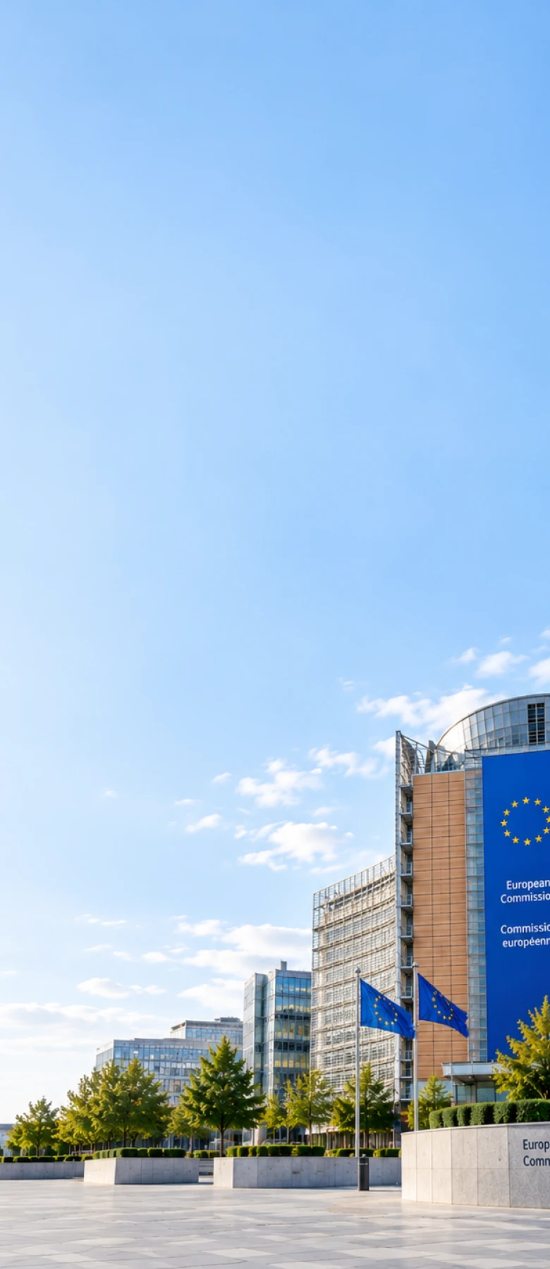 The European Commission's Berlaymont building in Brussels under the EU flag, representing the European Union jurisdiction Matterwire tracks regulatory change in.